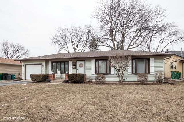 236 Kingsbridge Road Elk Grove Village, IL 60007 - Photo 1 of 13 a front view of a house with a yard