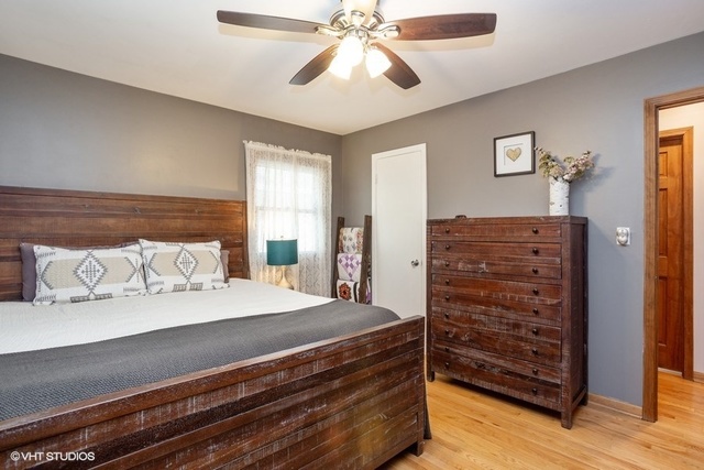 236 Kingsbridge Road Elk Grove Village, IL 60007 - Photo 6 of 13 a bedroom with a bed and a chandelier