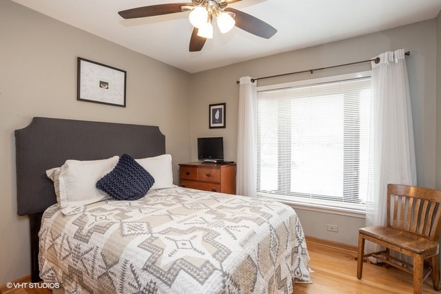 236 Kingsbridge Road Elk Grove Village, IL 60007 - Photo 8 of 13 a bedroom with a large bed and a window