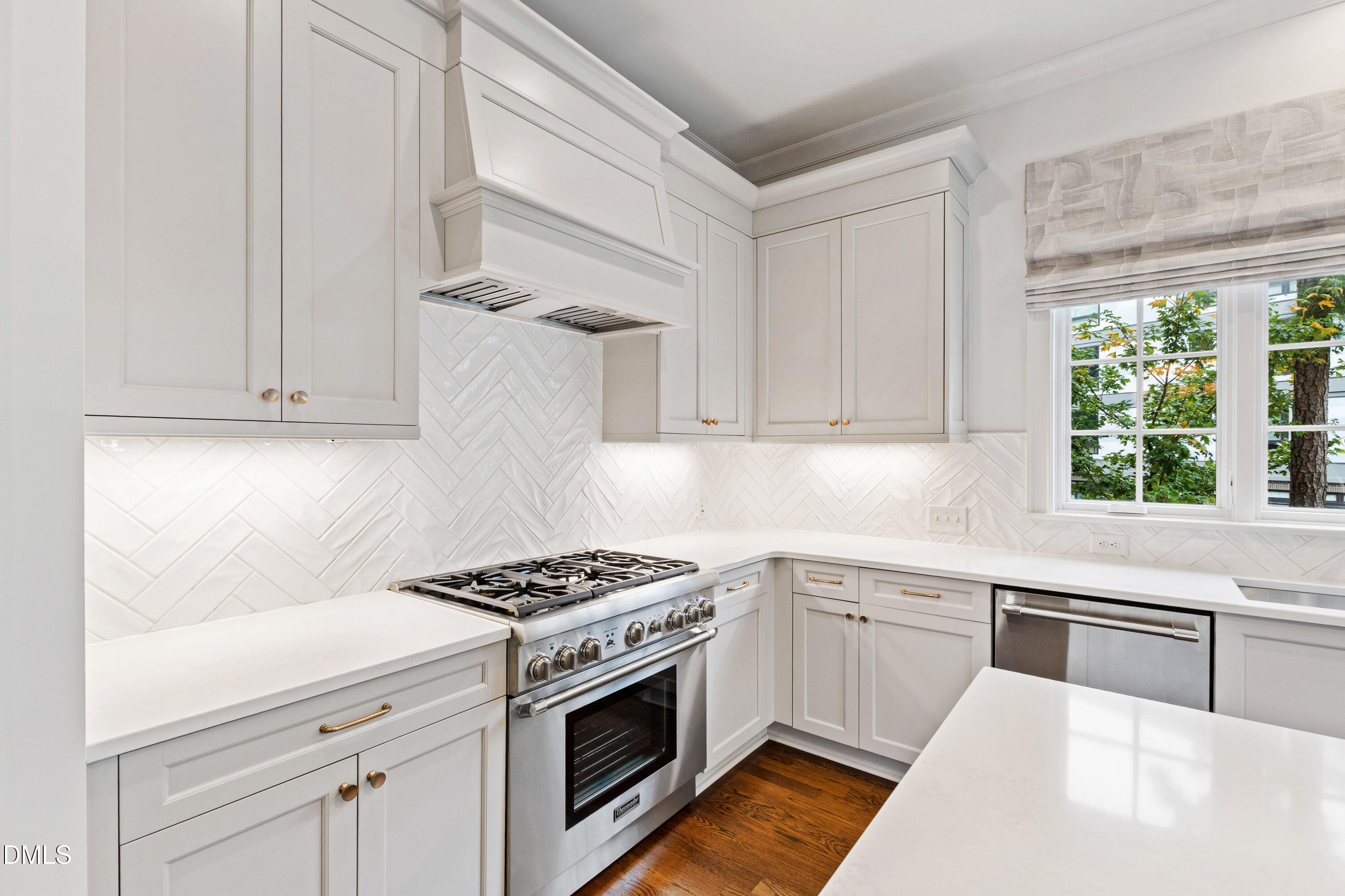 620 Wade Avenue, Unit 103 Raleigh, NC 27605 - Photo 14 of 41 a kitchen with white cabinets and appliances