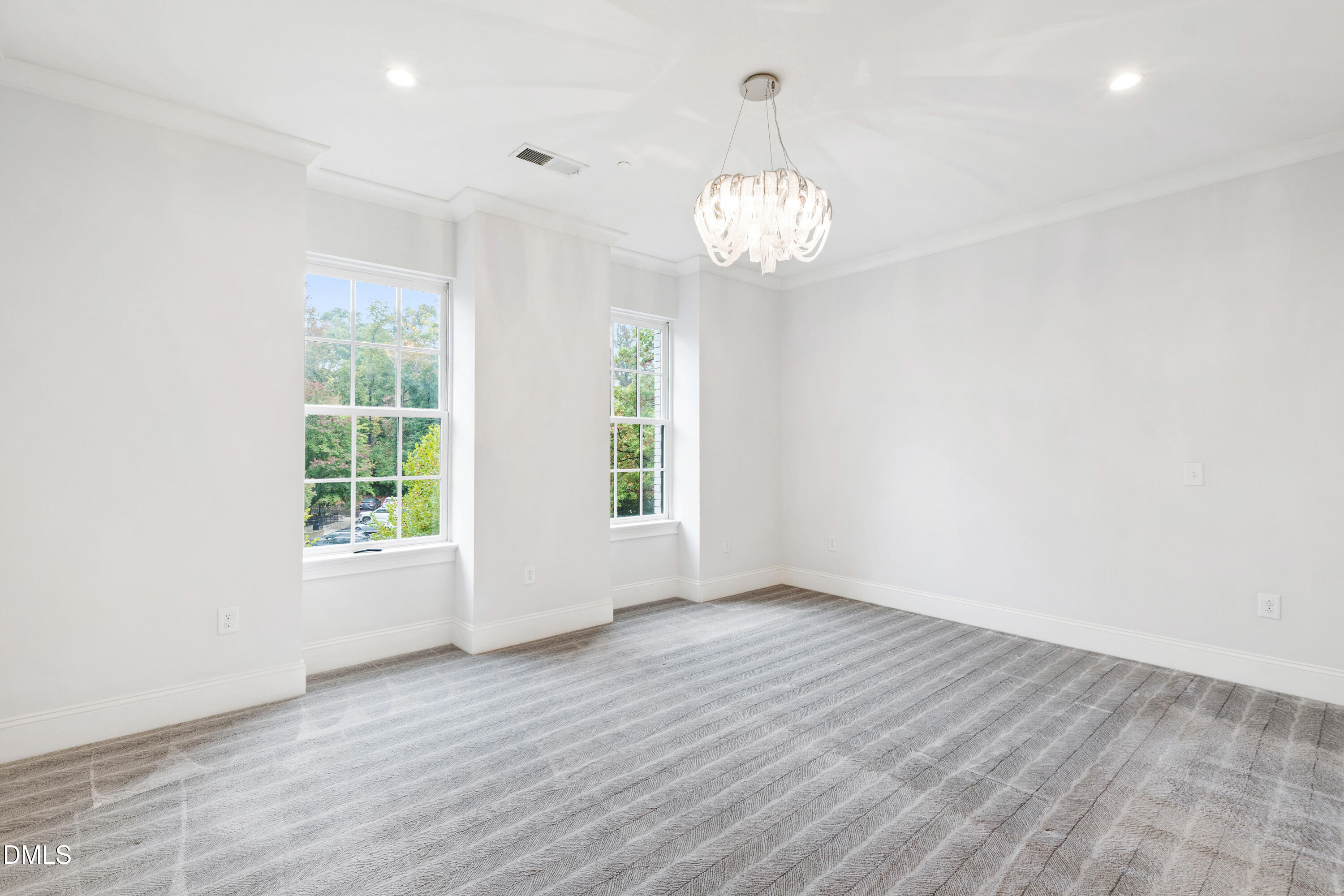 620 Wade Avenue, Unit 103 Raleigh, NC 27605 - Photo 17 of 41 an empty room with wooden floor and windows