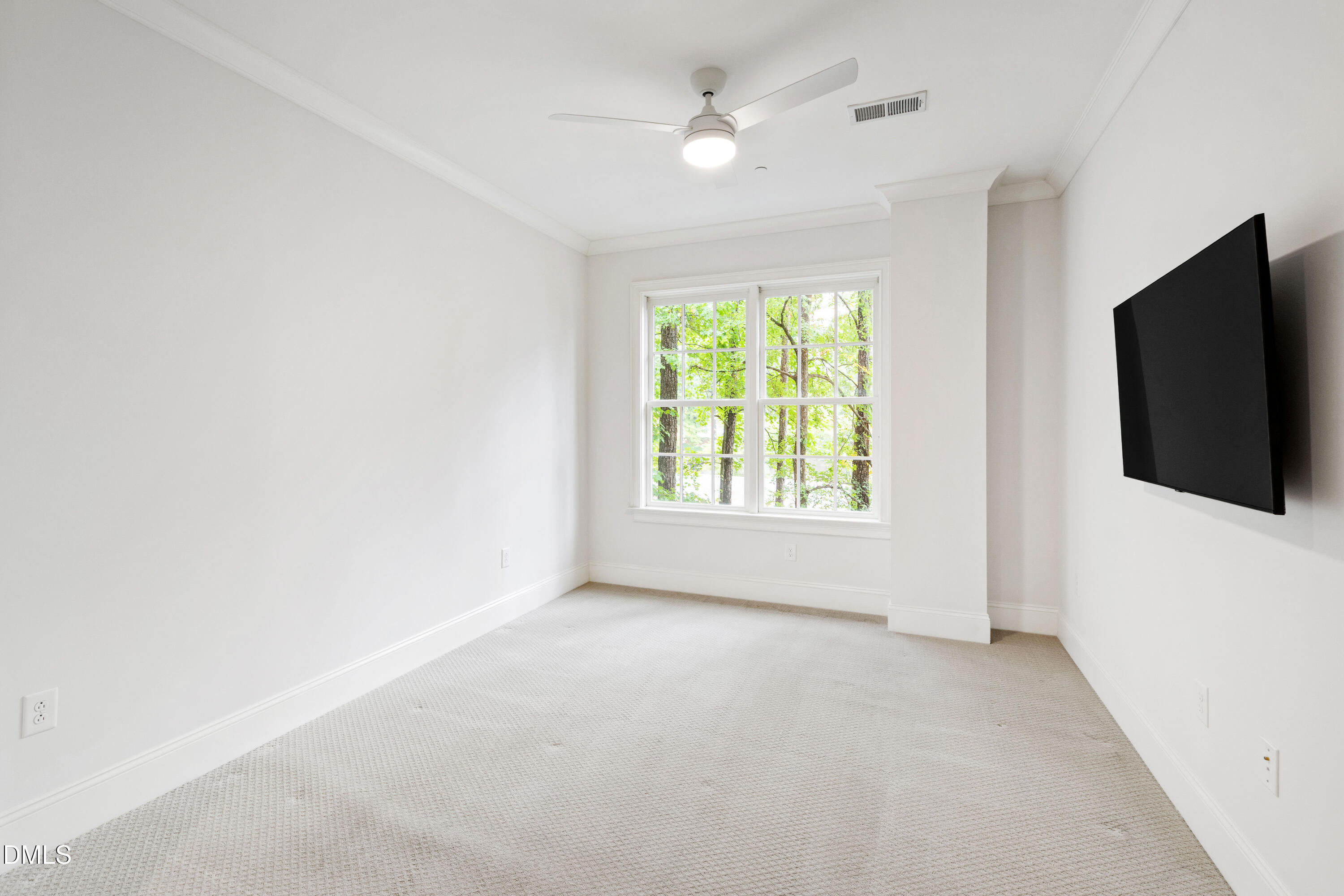 620 Wade Avenue, Unit 103 Raleigh, NC 27605 - Photo 20 of 41 an empty room with chandelier fan and windows