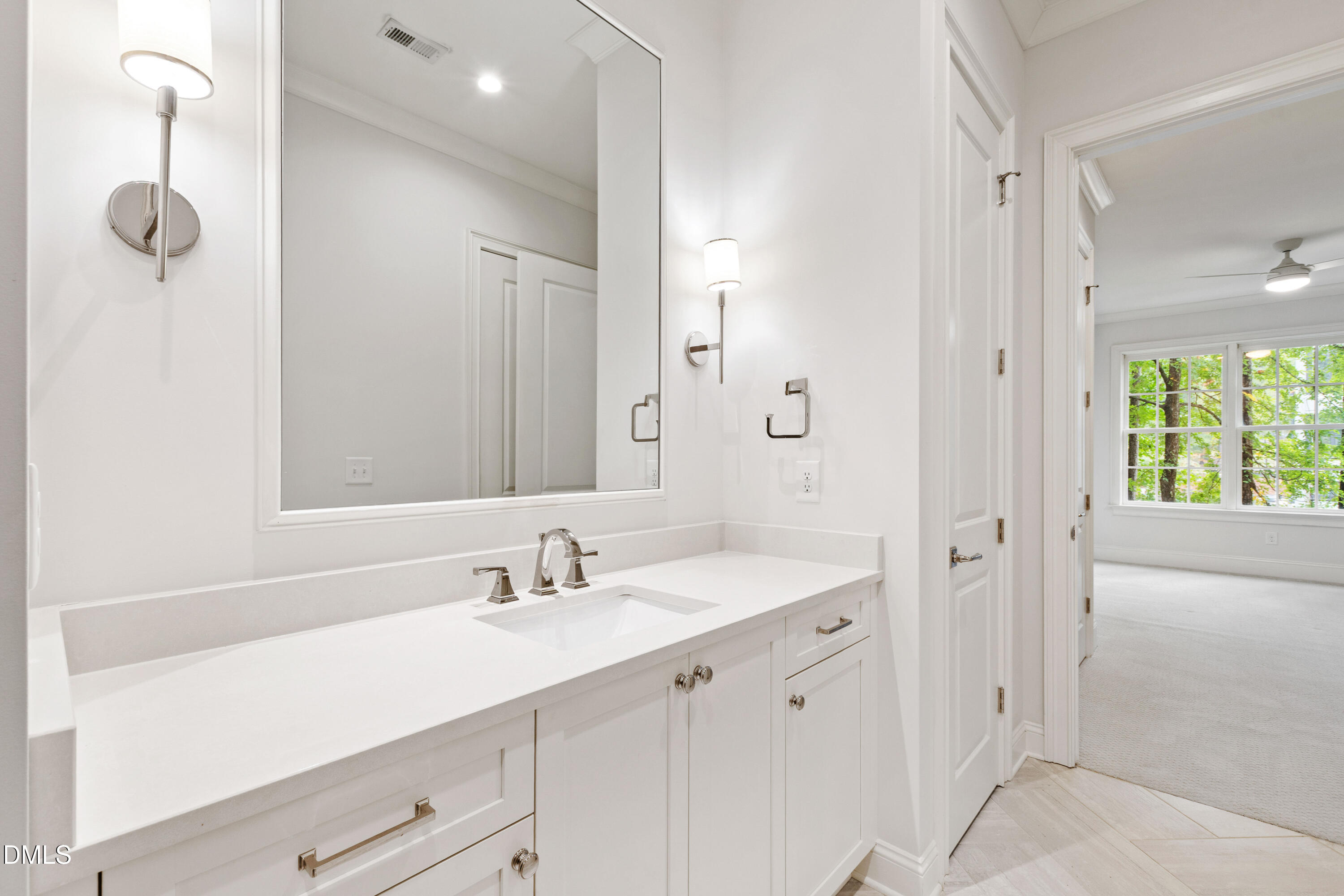 620 Wade Avenue, Unit 103 Raleigh, NC 27605 - Photo 22 of 41 a bathroom with a shower sink vanity and mirror