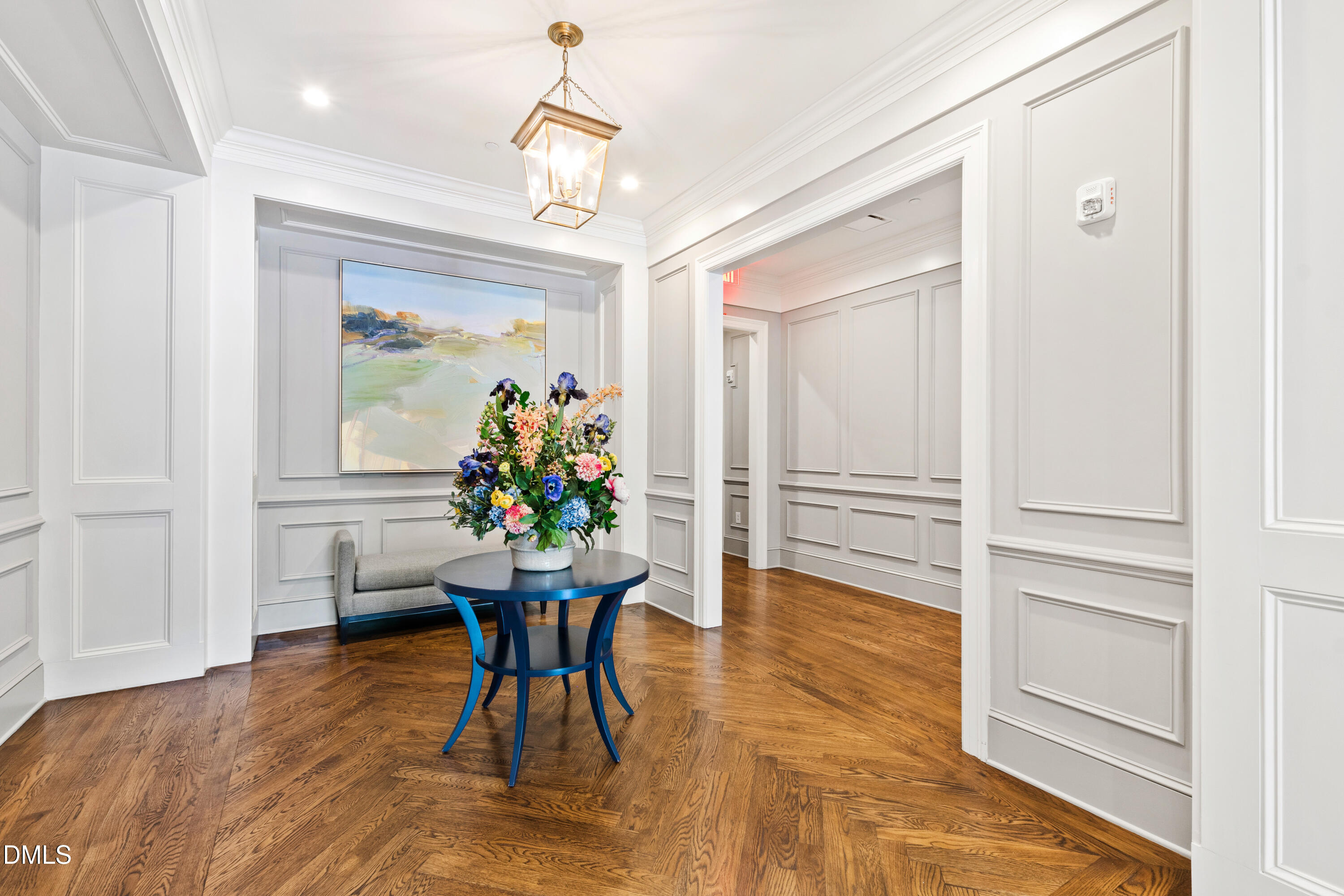 620 Wade Avenue, Unit 103 Raleigh, NC 27605 - Photo 28 of 41 a dining room with furniture a chandelier and wooden floor
