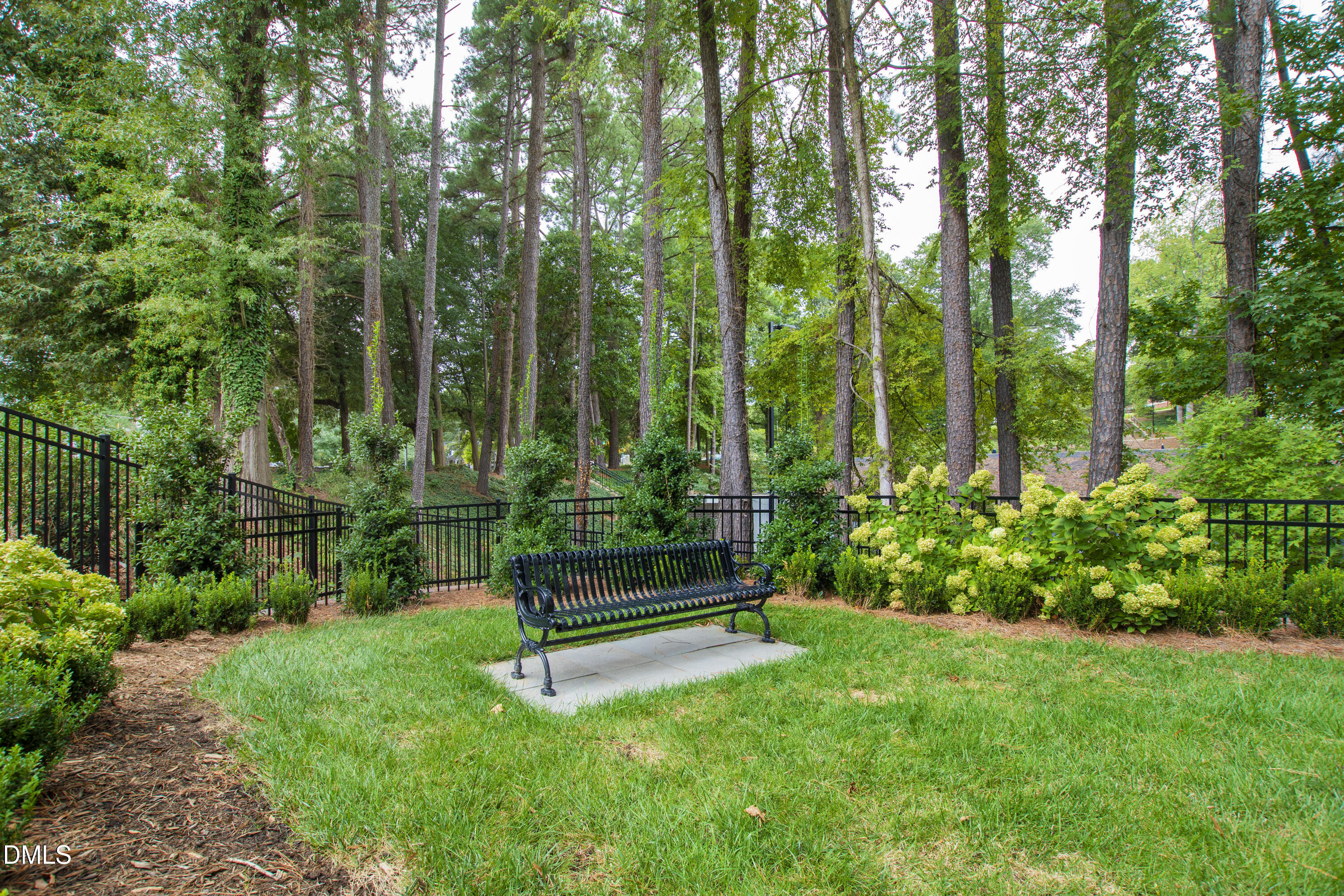 620 Wade Avenue, Unit 103 Raleigh, NC 27605 - Photo 35 of 41 a view of a bench in the garden