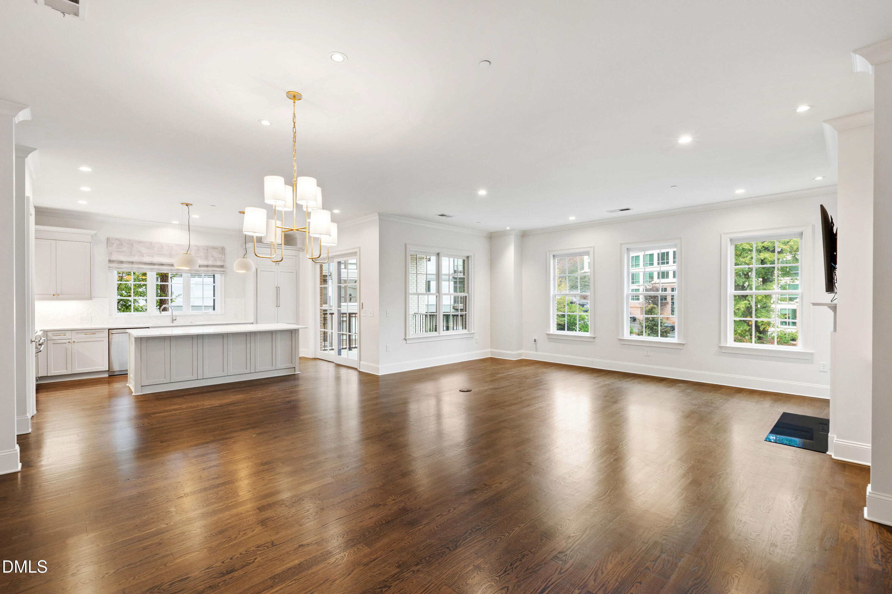 620 Wade Avenue, Unit 103 Raleigh, NC 27605 - Photo 4 of 41 a view of an empty room with wooden floor and kitchen view