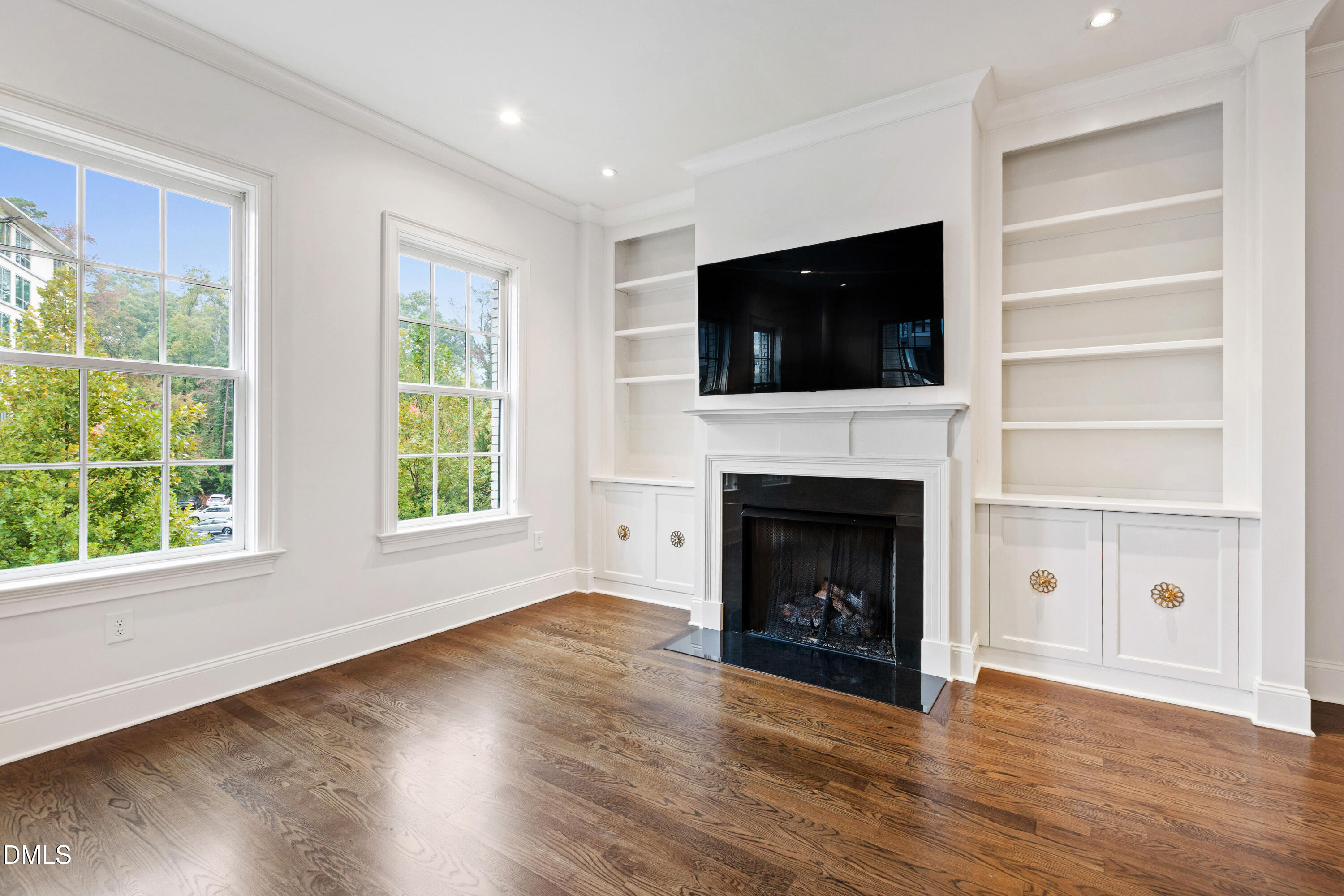 620 Wade Avenue, Unit 103 Raleigh, NC 27605 - Photo 7 of 41 a living room with a fireplace and a flat screen tv