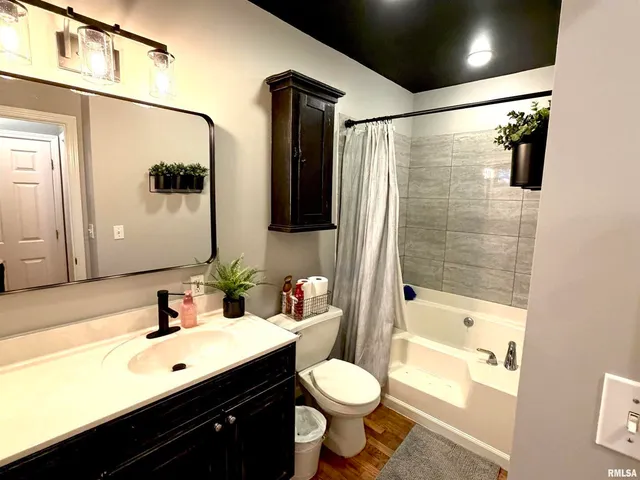 a bathroom with a double vanity sink toilet and shower