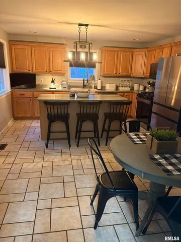 a kitchen with a sink a stove a table and chairs