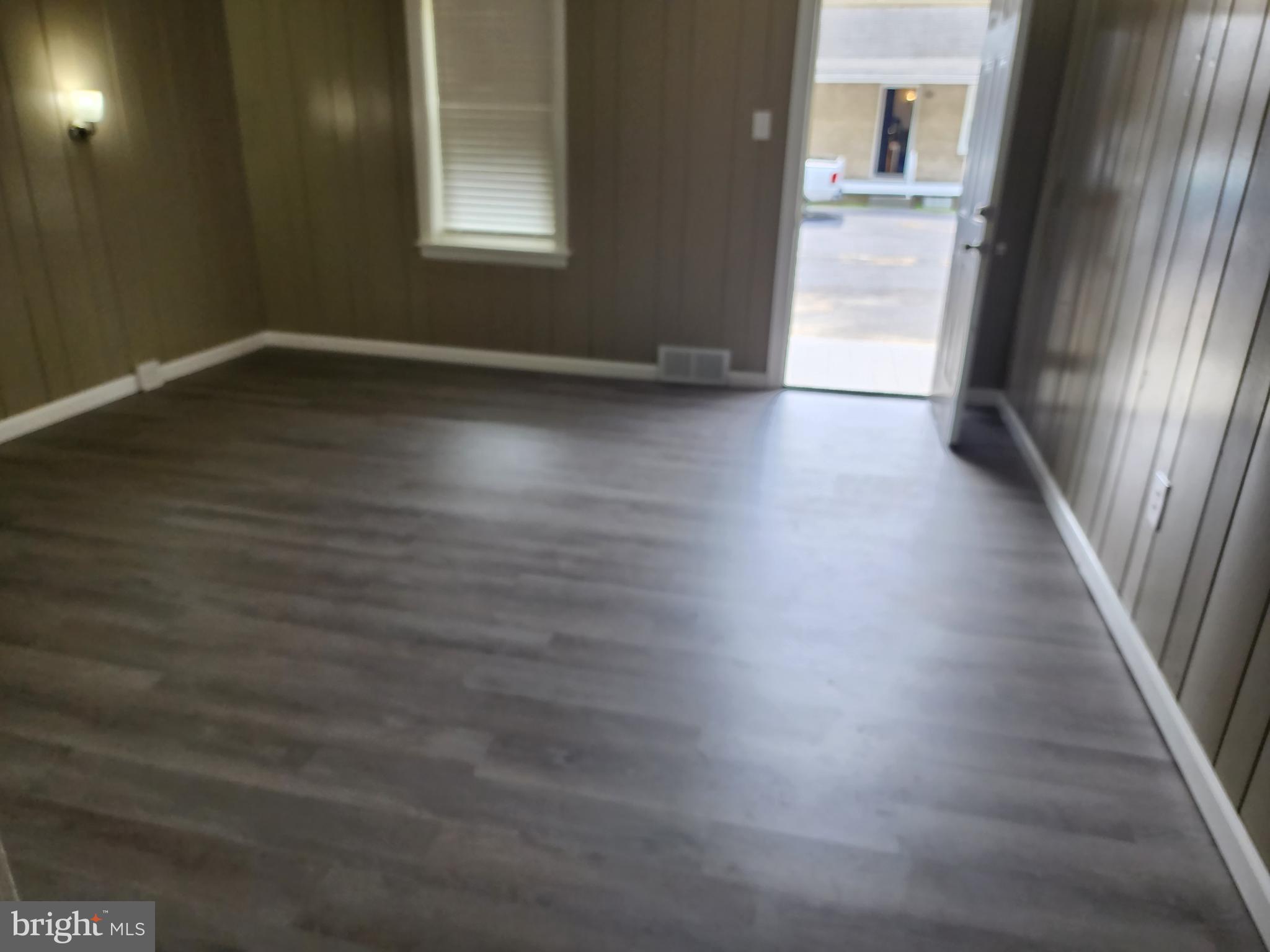 1816 Valley Avenue, Unit 3 Winchester, VA 22601 - Photo 4 of 7 a view of an empty room with wooden floor and a window