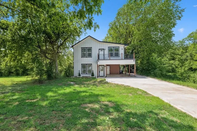 a front view of a house with a garden and porch