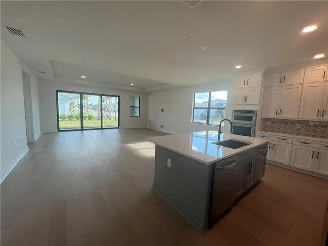 a spacious bathroom with a double vanity sink a mirror and a shower