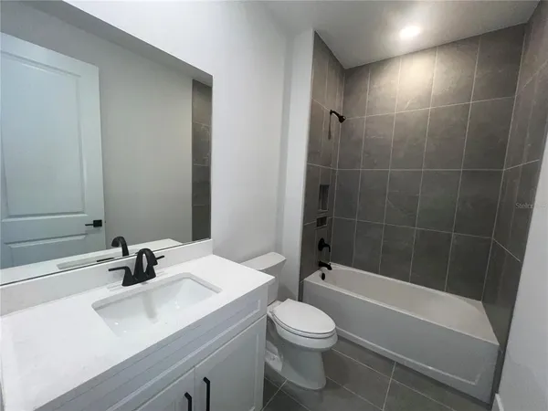 a kitchen with granite countertop white cabinets and a stove