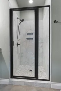 a bathroom with a glass shower door