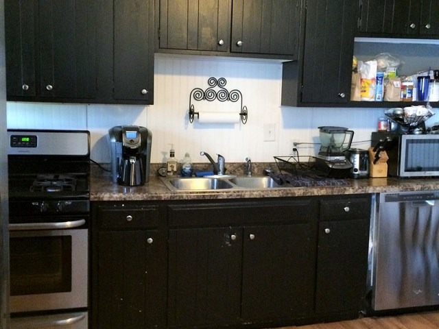115 East Madison Street Batavia, IL 60510 - Photo 11 of 23 a kitchen with granite countertop a sink stainless steel appliances and cabinets