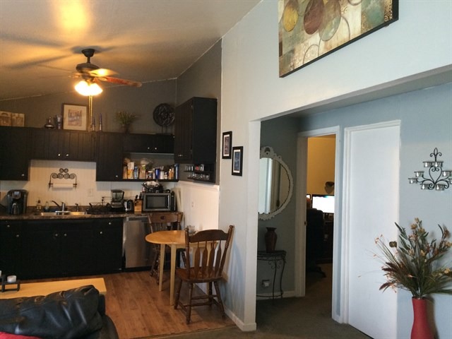 115 East Madison Street Batavia, IL 60510 - Photo 12 of 23 a kitchen with stainless steel appliances granite countertop a refrigerator a stove a sink dishwasher and white cabinets with wooden floor