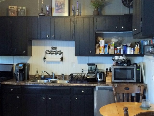 115 East Madison Street Batavia, IL 60510 - Photo 14 of 23 a kitchen with a sink a stove and cabinets