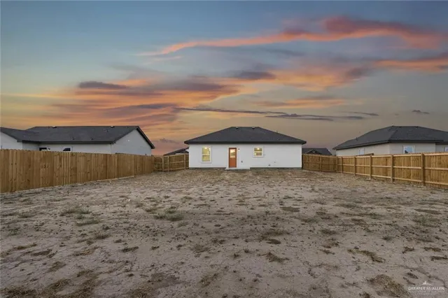 a view of a house with a backyard