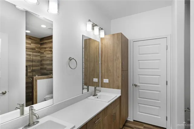 a bathroom with a double vanity sink and mirror