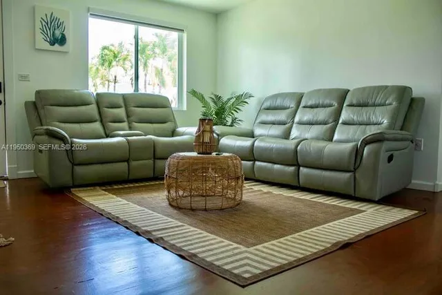 a living room with furniture rug and window