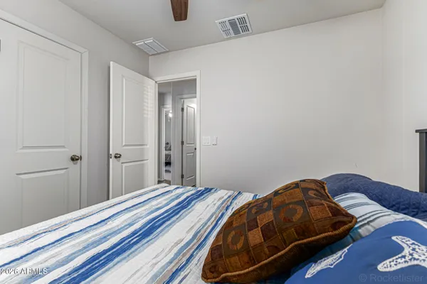 a bedroom with a bed and a lamp