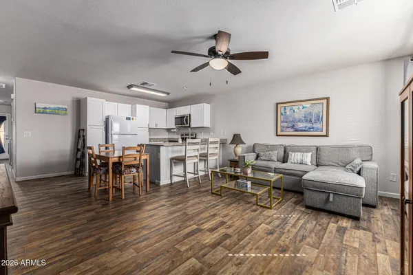 a living room with lots of furniture and kitchen view