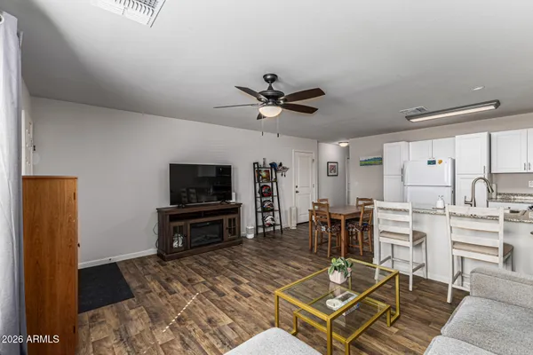 a living room with furniture a flat screen tv and a table