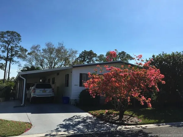 a view of house with outdoor space and sitting area