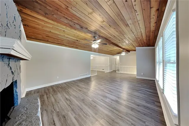 a kitchen with granite countertop a refrigerator oven a sink dishwasher and a refrigerator with wooden floor