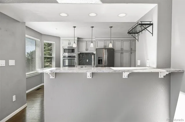a view of a kitchen with a sink and windows