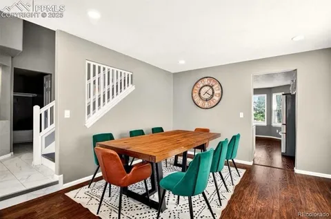 a view of a dining room with furniture and wooden floor