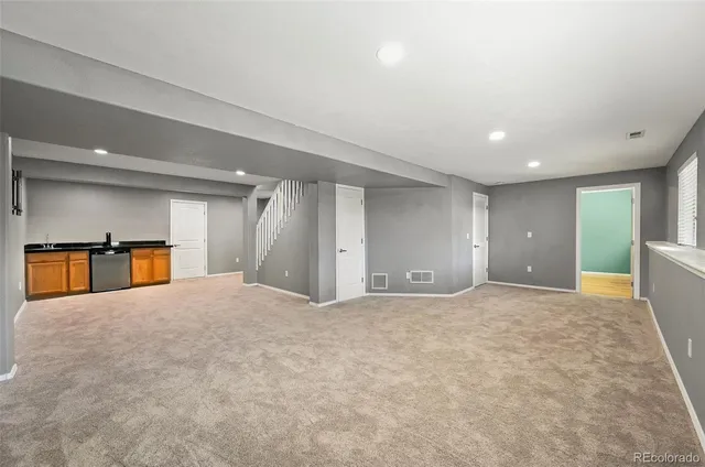 a view of a big room with closet and windows