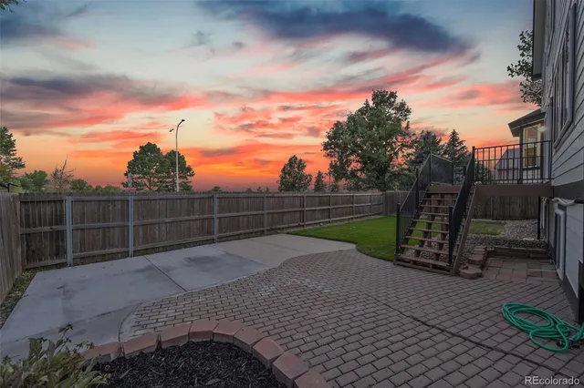 a view of backyard with wooden fence