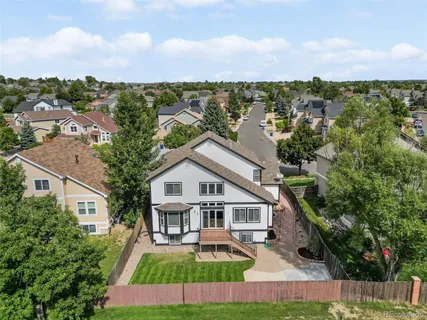 an aerial view of a house with a yard