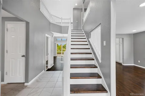 a view of entryway and hall with wooden floor