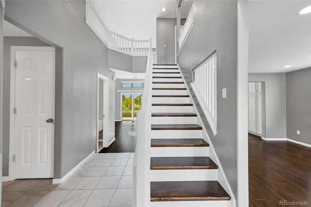 a view of entryway and hall with wooden floor