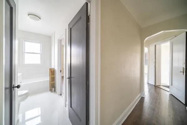 a view of a bathroom with a tub shower and hardwood floor