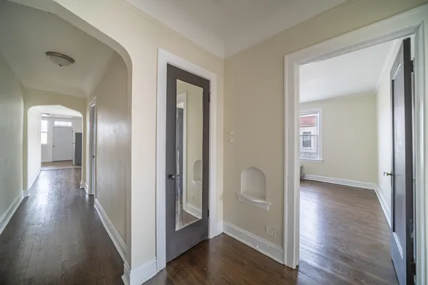 a view of a hallway with wooden floor