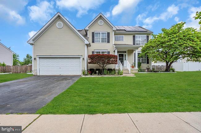 a front view of house with yard and green space
