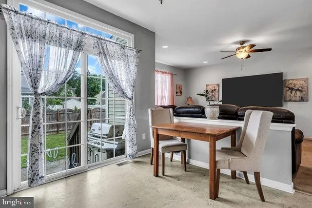 a room with furniture a flat screen tv and a window