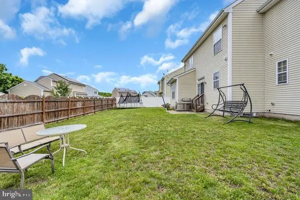 a view of a house with backyard and a tree