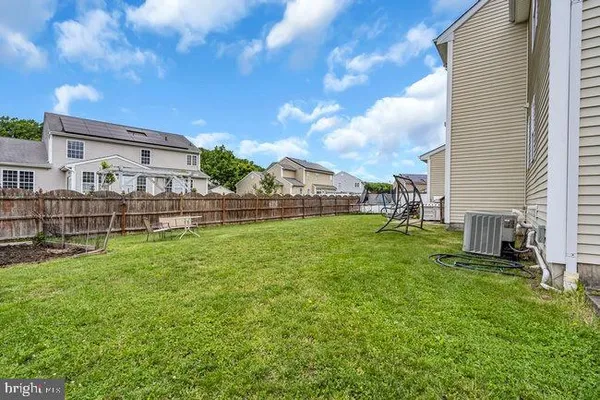 a view of a house with a big yard and a fountain