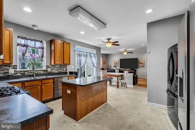 a view of kitchen with sink and living room