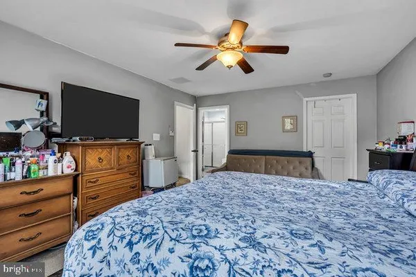 a bedroom with a bed and flat screen tv