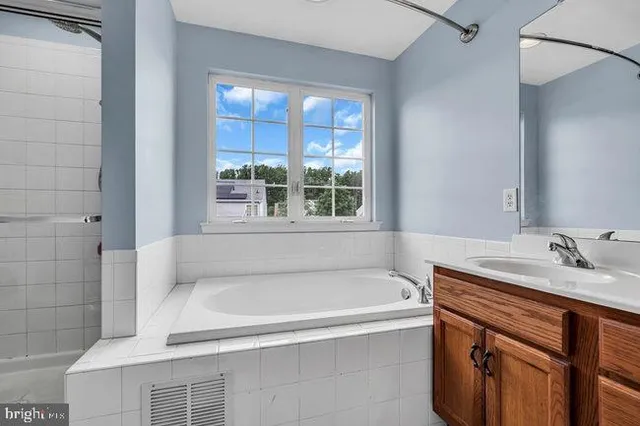 a bathroom with a bathtub and a sink