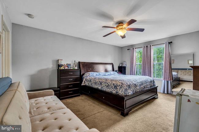 30 Homestead Drive Pemberton, NJ 08068 - Photo 36 of 51 a bedroom with a bed and a chandelier