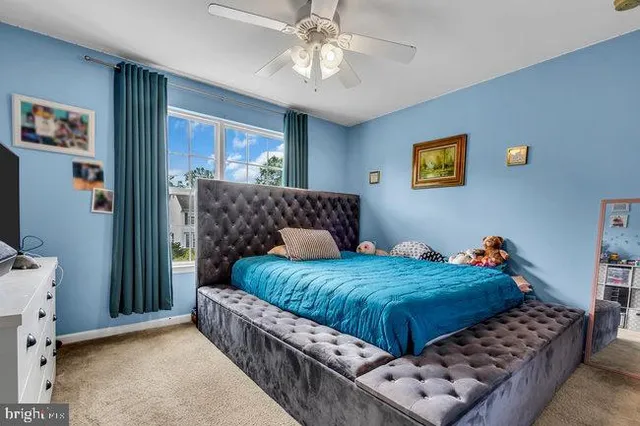 a bedroom with bed and a window