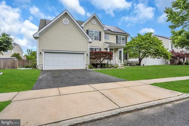 a front view of house with yard and green space