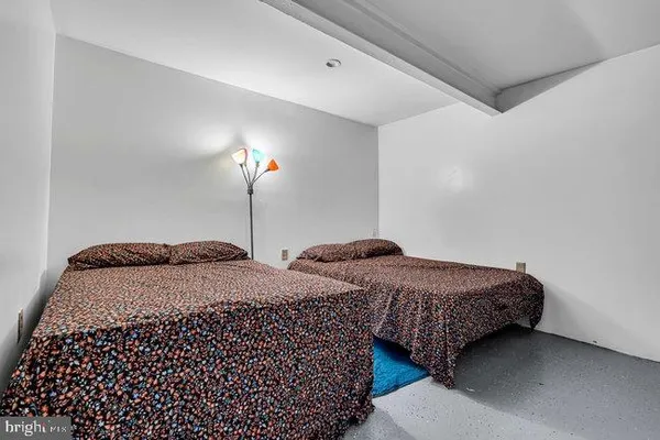 a bedroom with bed and a lamp
