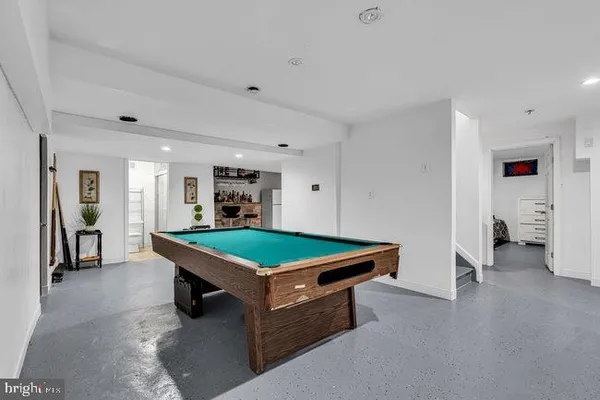 a room with pool table and windows